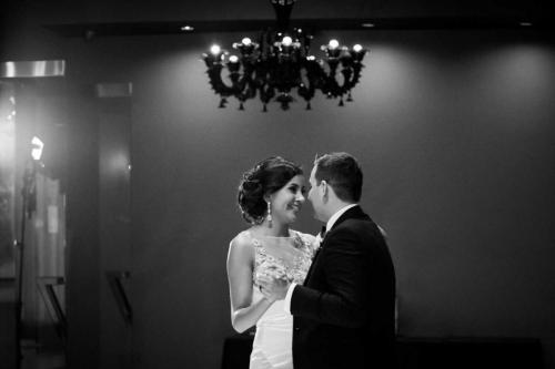 wedding-couple-bride-groom-dancing-inside-vertigo-event-venue-black-white-photo